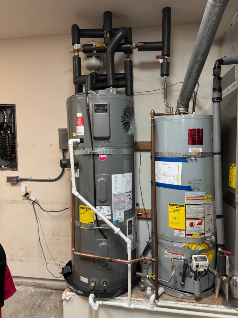 Two Rheem gas water heaters installed in a single system.