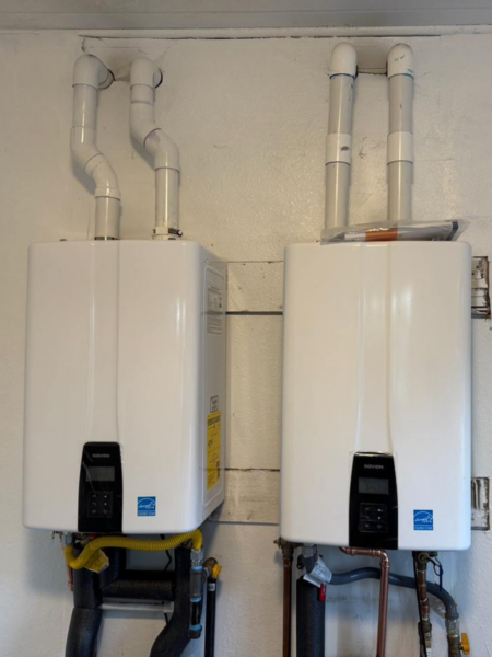 Two white, identical Navien water heaters.