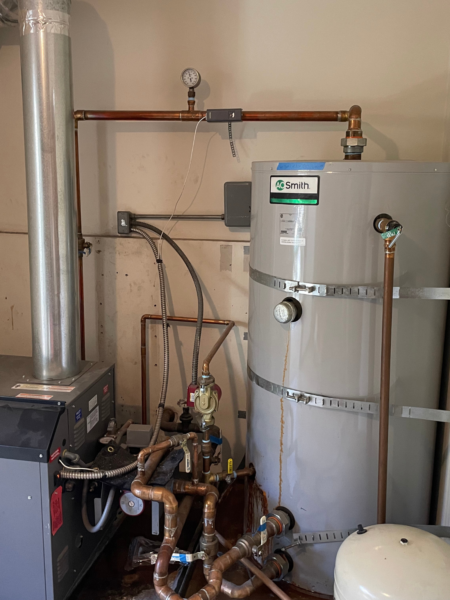 Smith water heater with boiler and copper pipes.