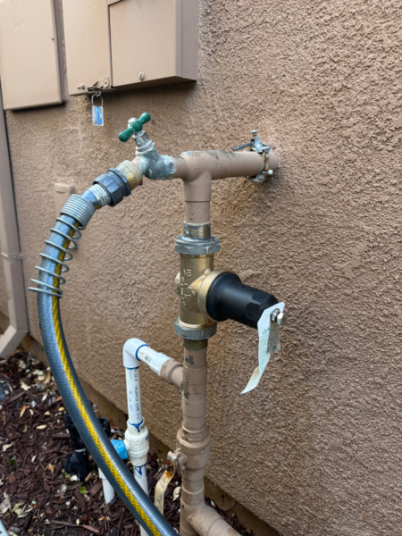 an outdoor water tap with several branches