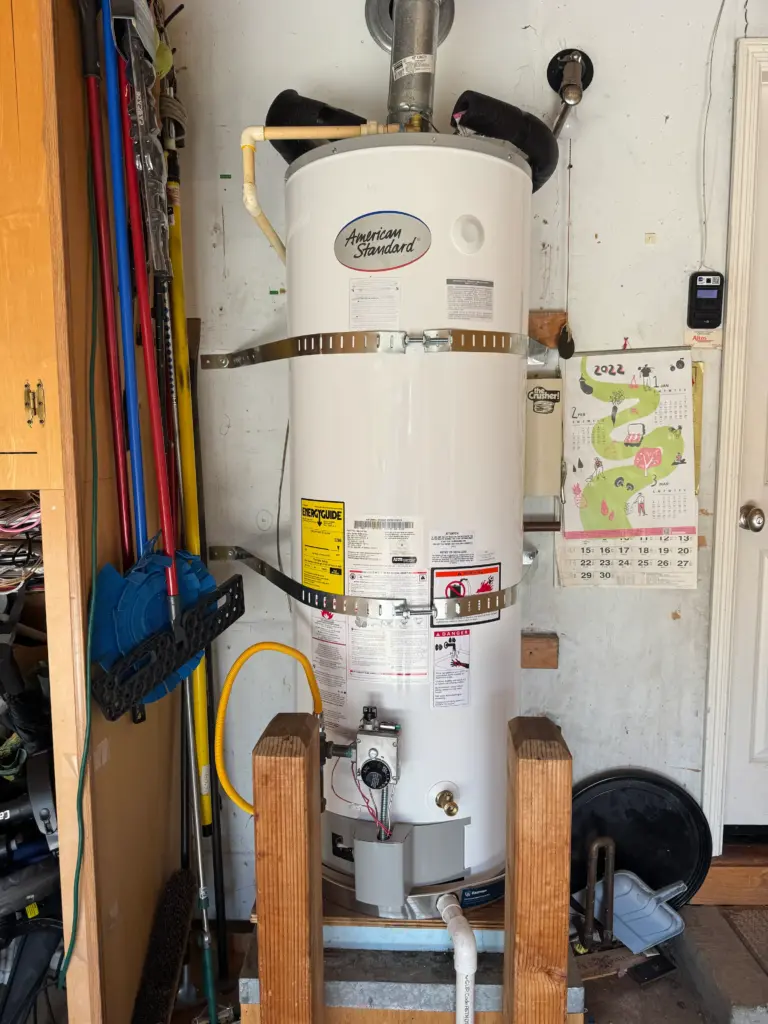 American 50 gallon water heater installed in a utility area