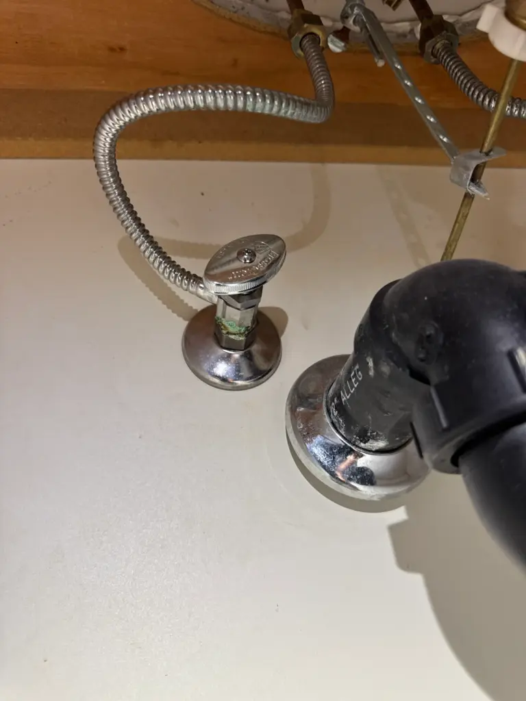 Angle stop valve replaced beneath a bathroom sink