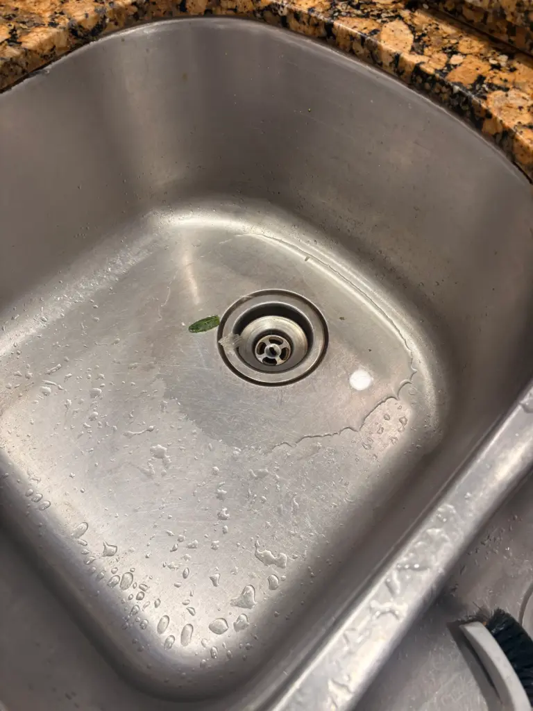 Kitchen sink drain cleared during drain cleaning service