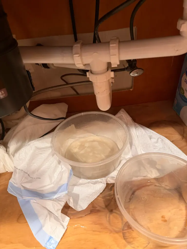 Leak visible beneath a kitchen sink