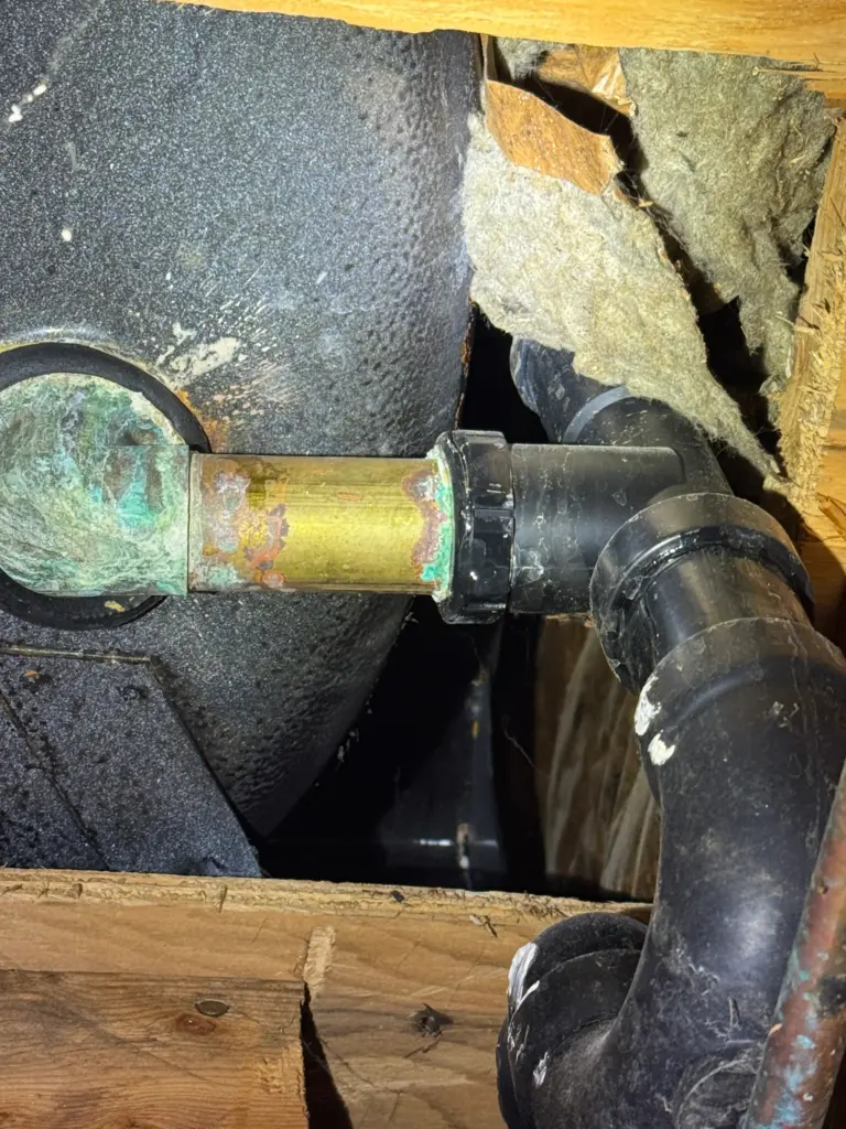 Plumber diagnosing a leak at an exterior water line