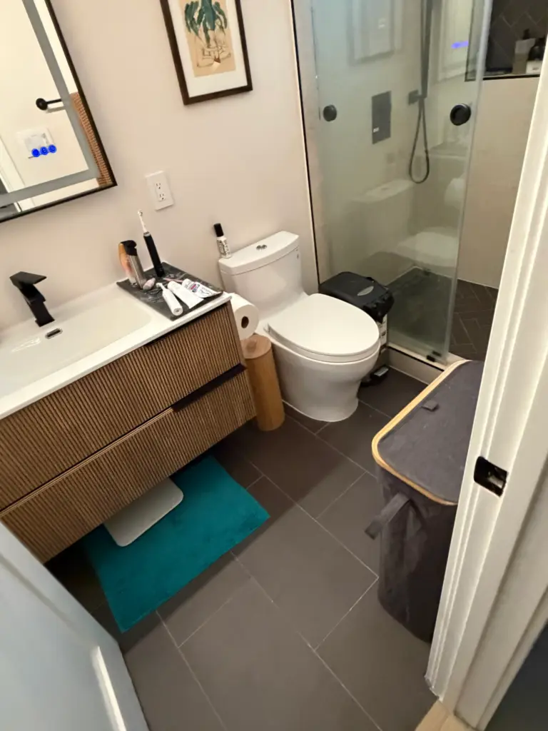 Shower enclosure being recaulked at the wall joint