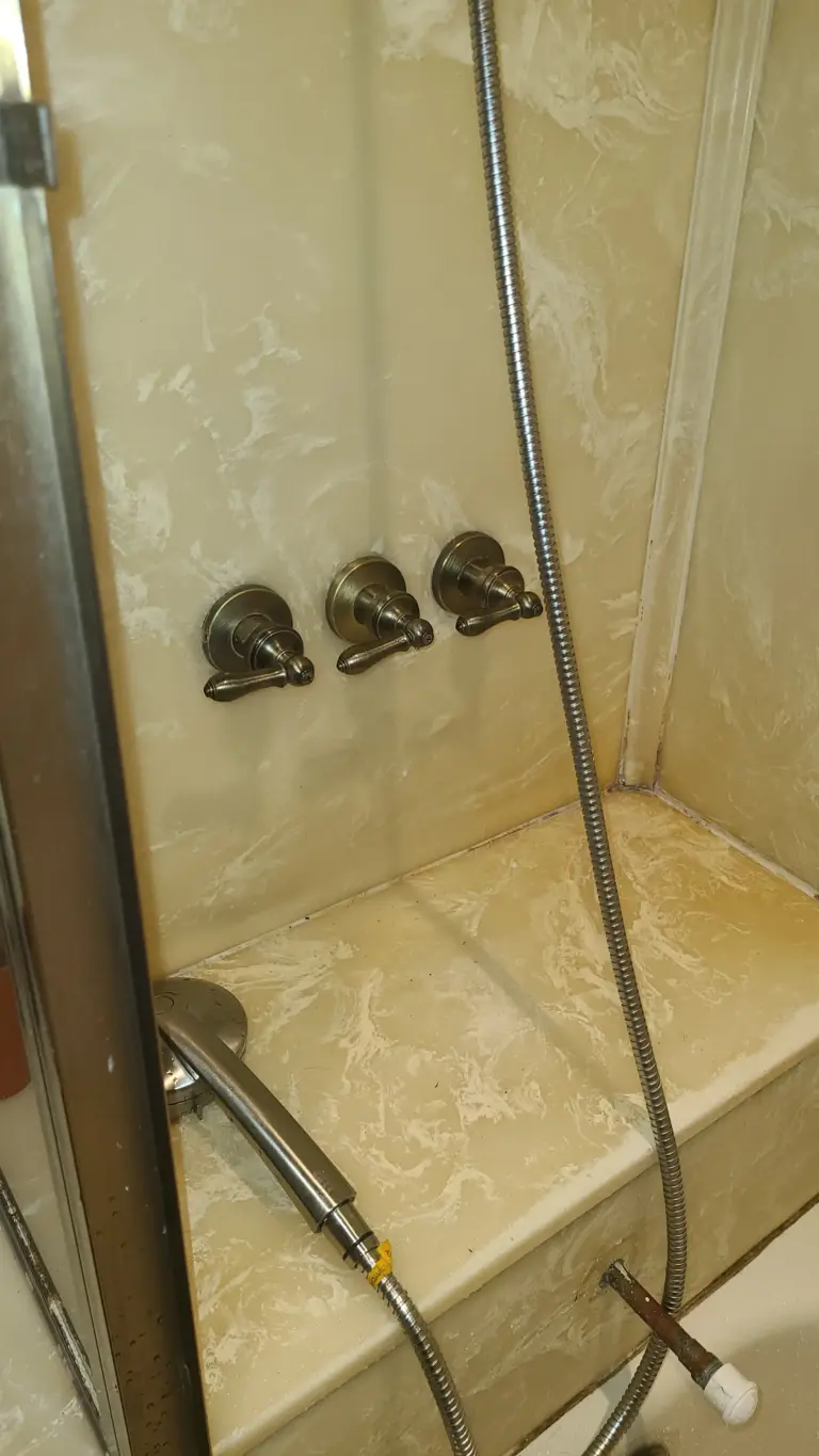 Plumber replacing a bathroom fixture cartridge