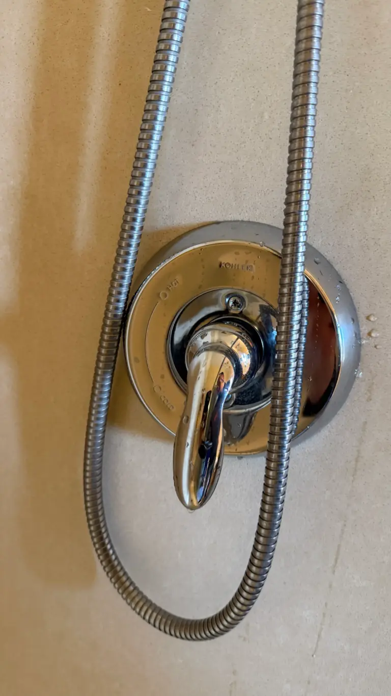 New showerhead installed in a tiled shower