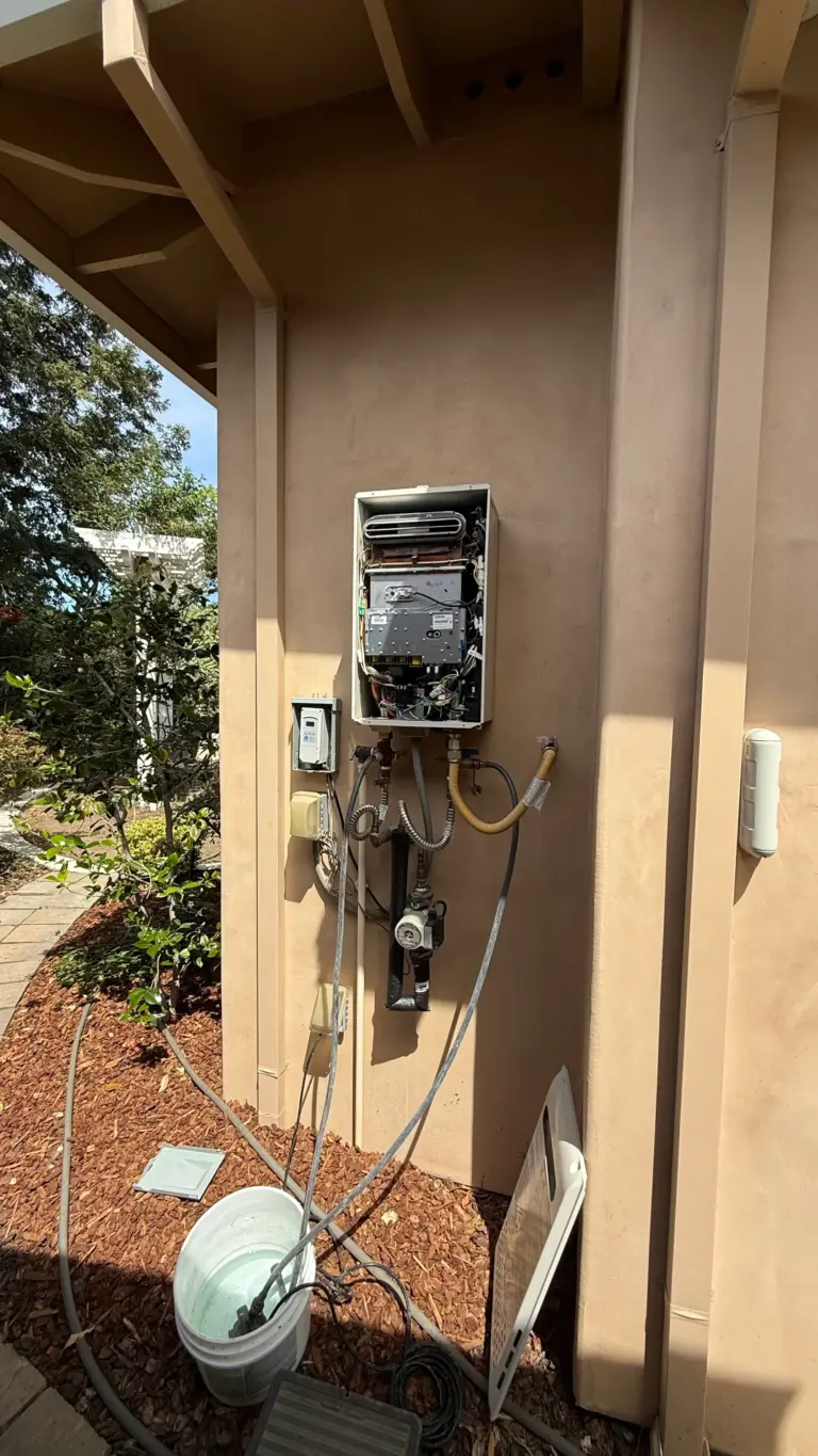 Tankless water heater installed on an exterior wall