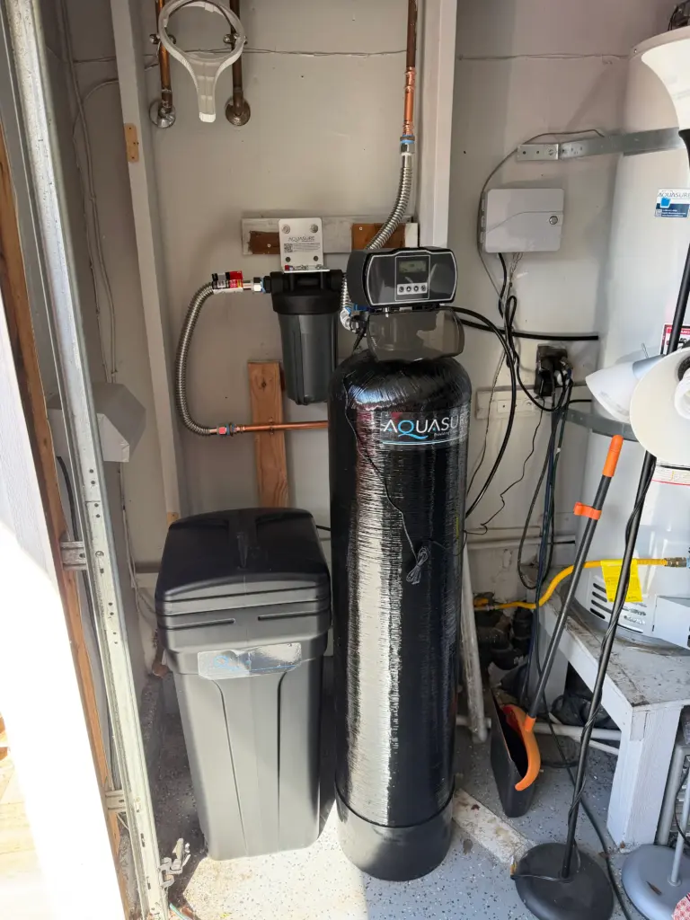 Water softener system installed with bypass and supply lines