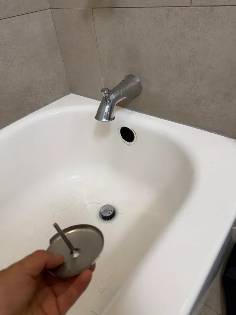 Plumber clearing an outdoor residential drain line