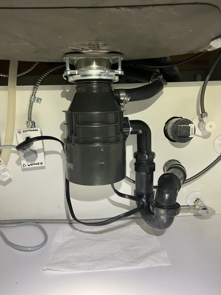 Garbage disposal installed beneath a kitchen sink