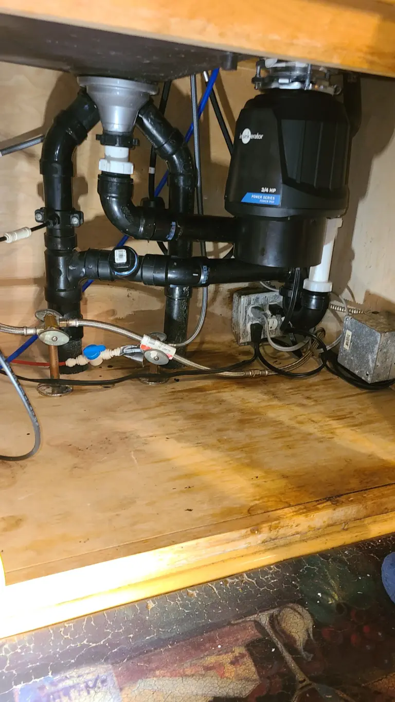 Garbage disposal installed beneath a kitchen sink