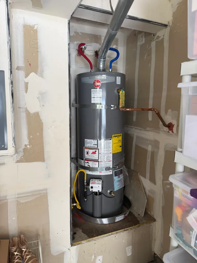 Gas tank water heater installed in a utility closet