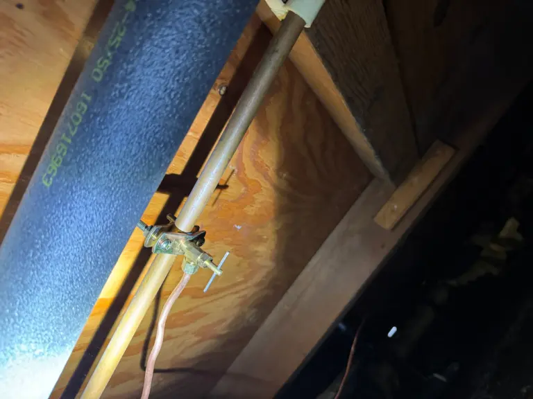Water line routed beneath cabinetry for an ice maker