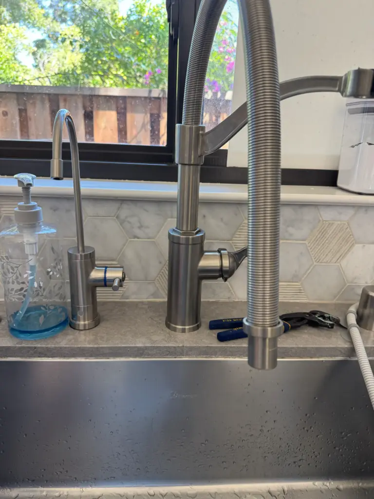 Kitchen faucet being replaced at a sink