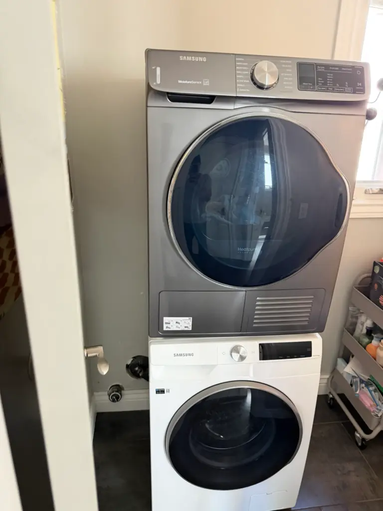 Laundry drain line servicing behind a washing machine