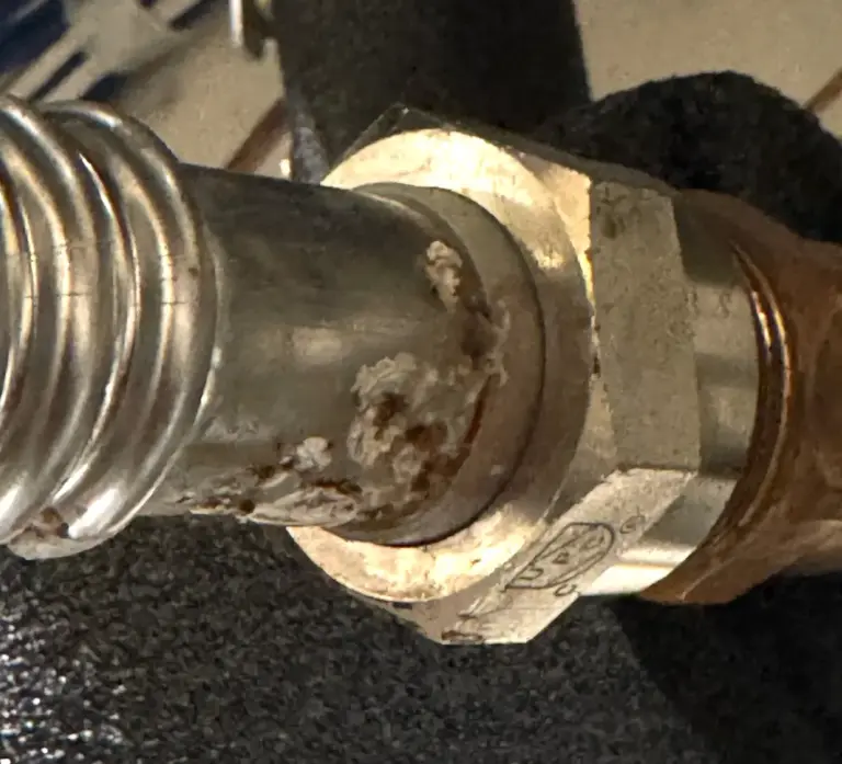 Damaged pipe connection being repaired