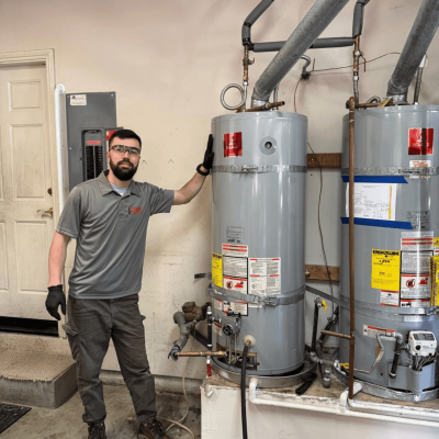 Person next to water heaters in garage